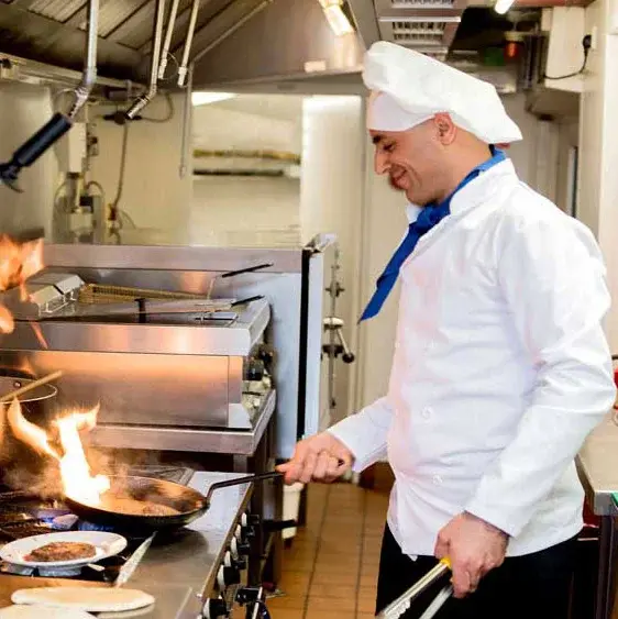 Ashwood Meadows Chef Created Meals, chef frying a dish.