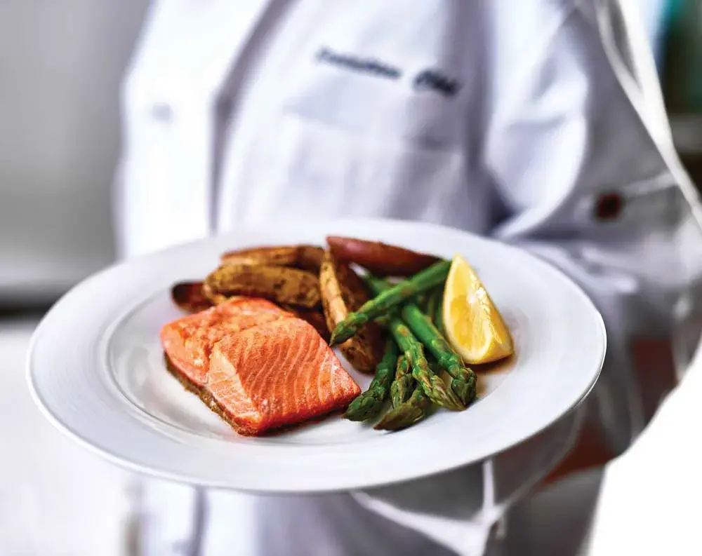 Ashwood Meadows Chef Created Meals, chef delivering a finished dish.